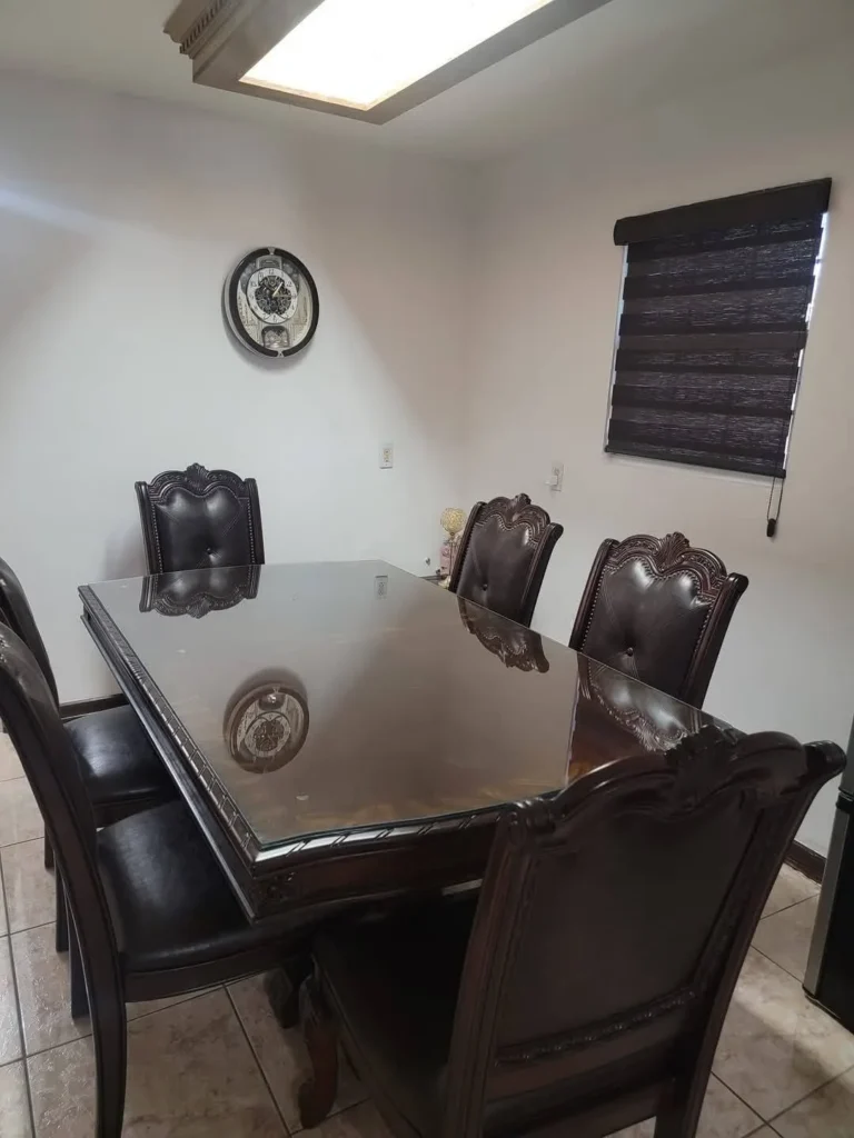 Custom-cut glass top on a dining table by USA GLASS